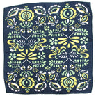 Navy blue fabric with green, yellow, and white floral pattern