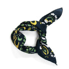 Navy blue scarf with green and yellow floral pattern on a white background