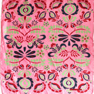 Pink fabric with black, green, and red floral pattern
