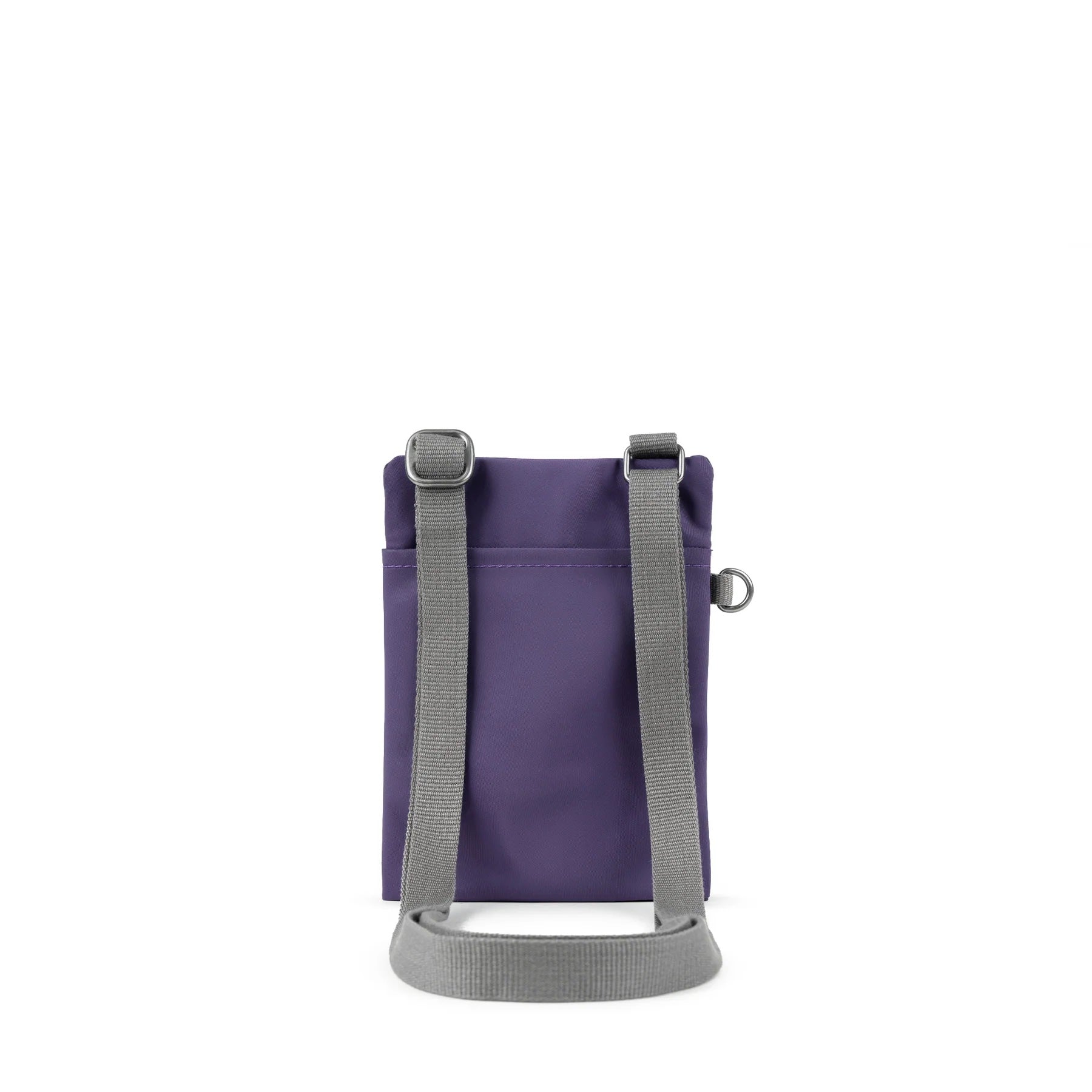 A photo of the back of a small rectangular purple pocket bag. It has a pocket and grey straps.