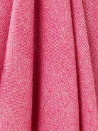 Close-up of pink fabric with a subtle pattern