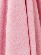 Close-up of pink fabric with a subtle pattern