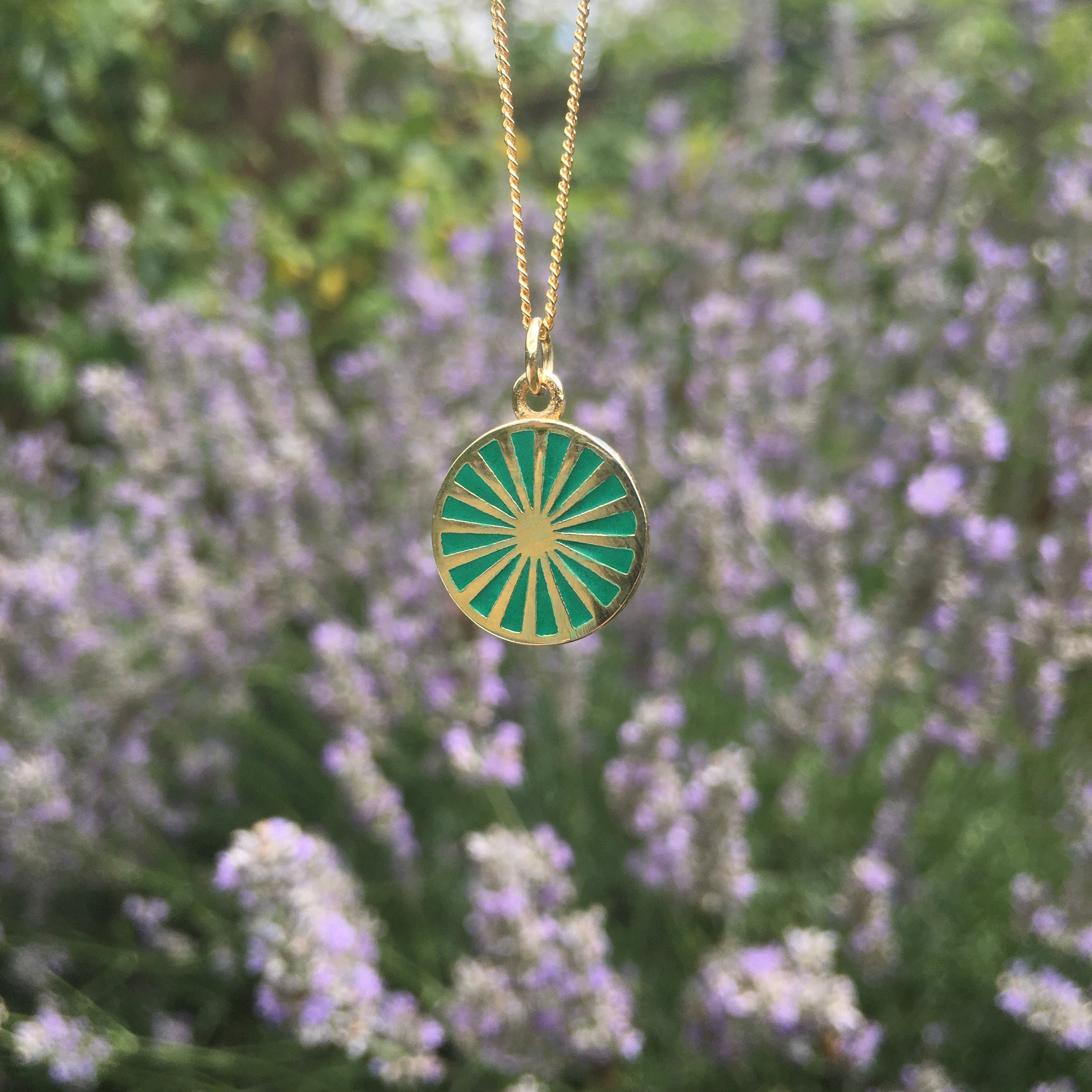 spinning wheel in green with gold vermeil in front of lavender plants