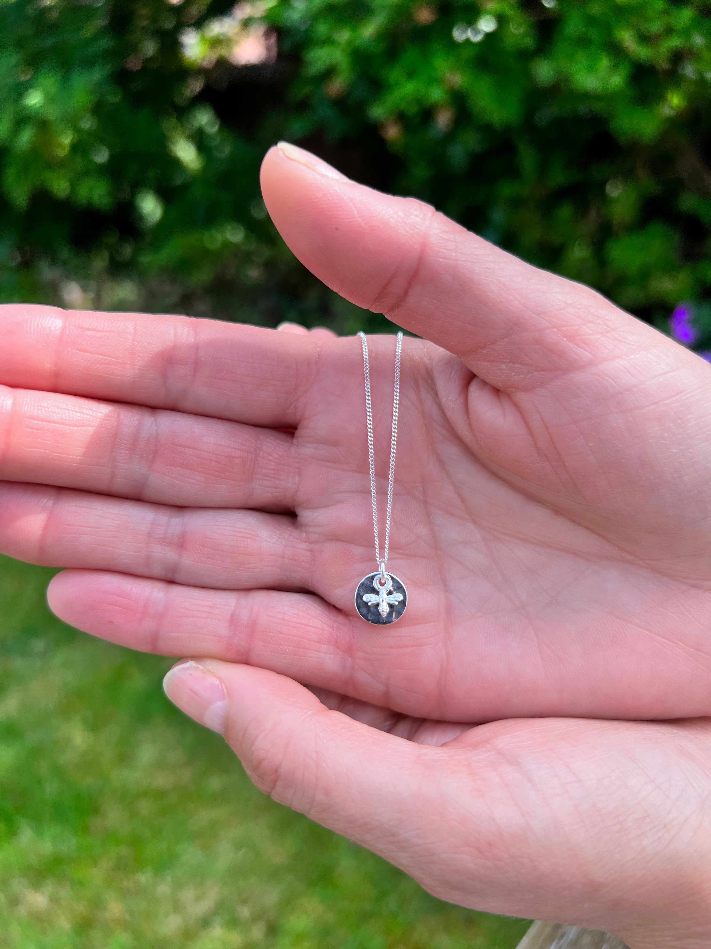 mini bee with hammered disc on hand