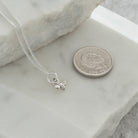 mini bee necklace next to 5p coinMini Bee Charm Necklace Sterling Silver