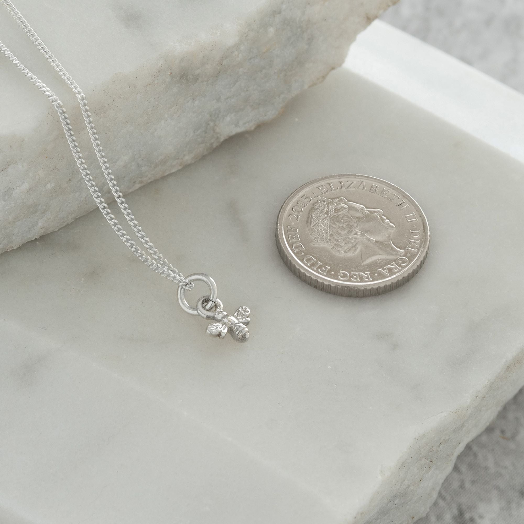 mini bee necklace next to 5p coinMini Bee Charm Necklace Sterling Silver