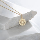 daisy necklace close up on marble stone