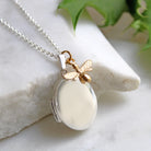 oval locket with gold bee