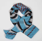 Colorful scarf with abstract patterns on a light gray background