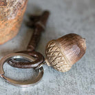 Keychain with acorn design on a textured surface