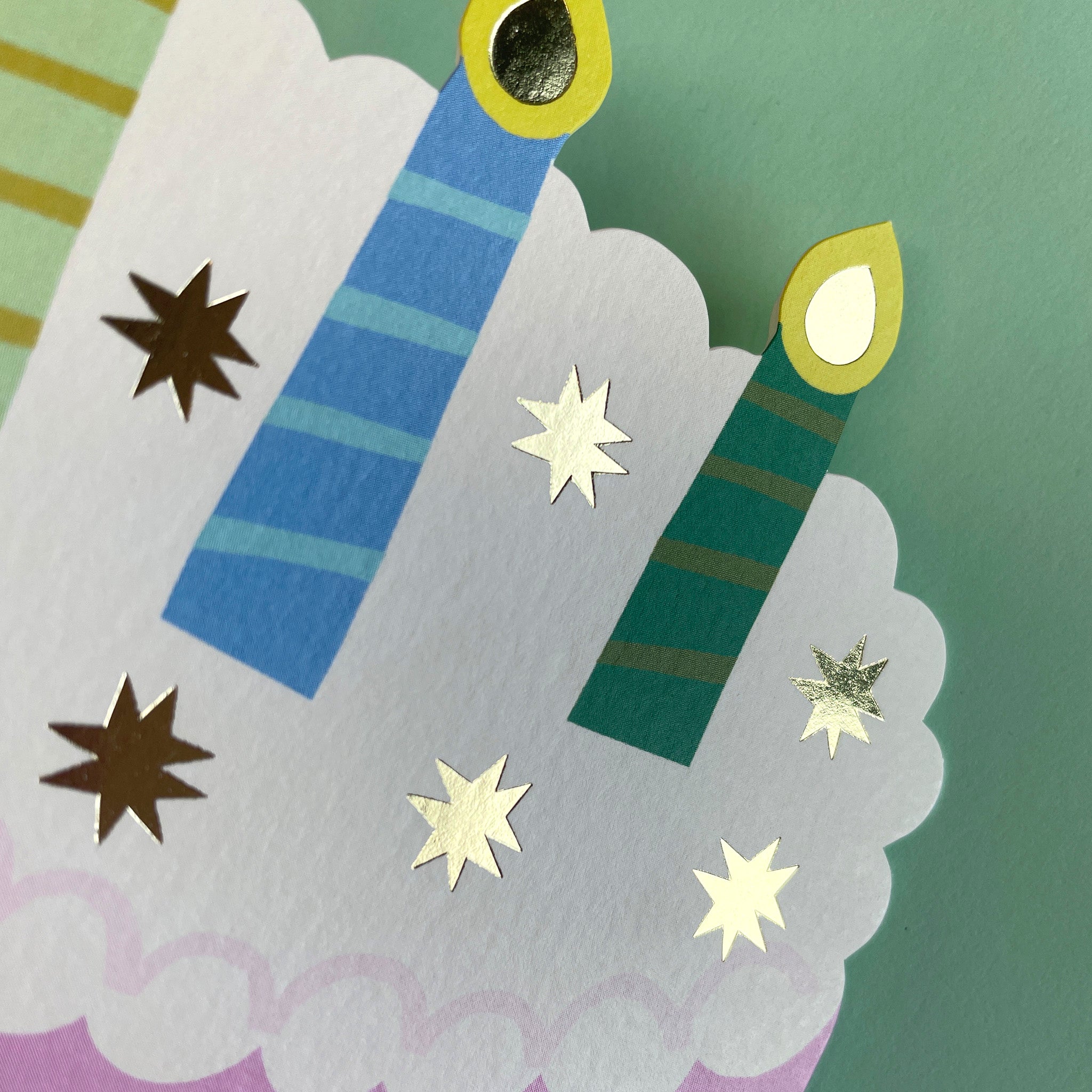 Decorative card with candles and stars on a green background