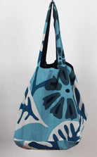 Blue floral patterned bag on a light gray background