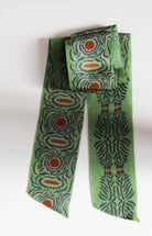 Green patterned scarf on a white background