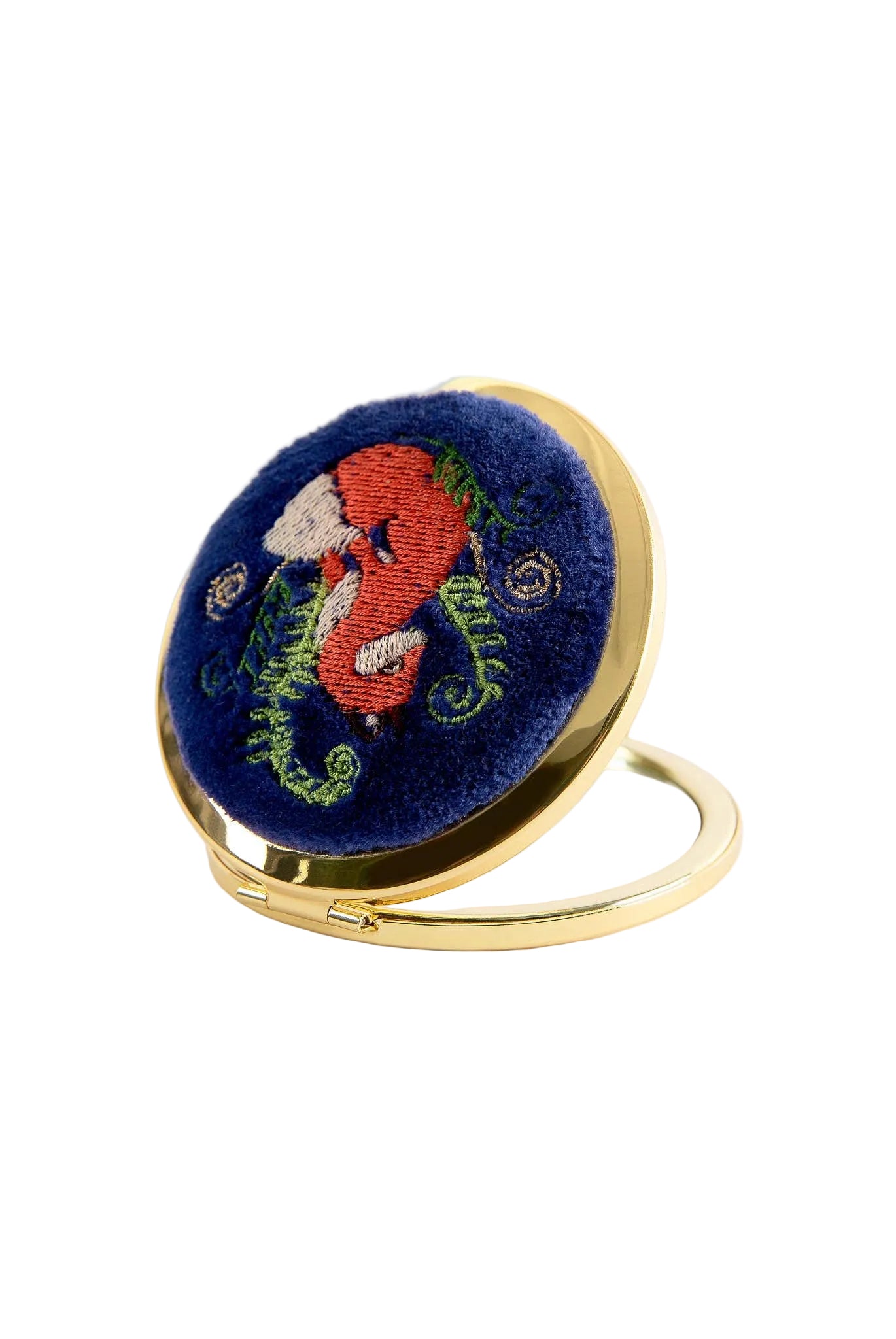 Compact mirror with embroidered design on a white background