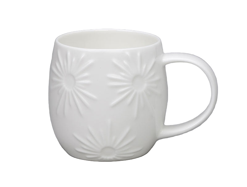 White ceramic mug with embossed design on a white background