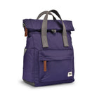 Purple backpack with grey straps on a white background