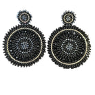 Pair of black and gold beaded earrings on a black background