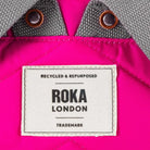 Close up image of a ROKA London label on a pink backpack