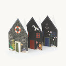 A row of concertina decorative paper houses with various designs on a white background
