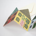 Colourful paper house concertina card on a white background