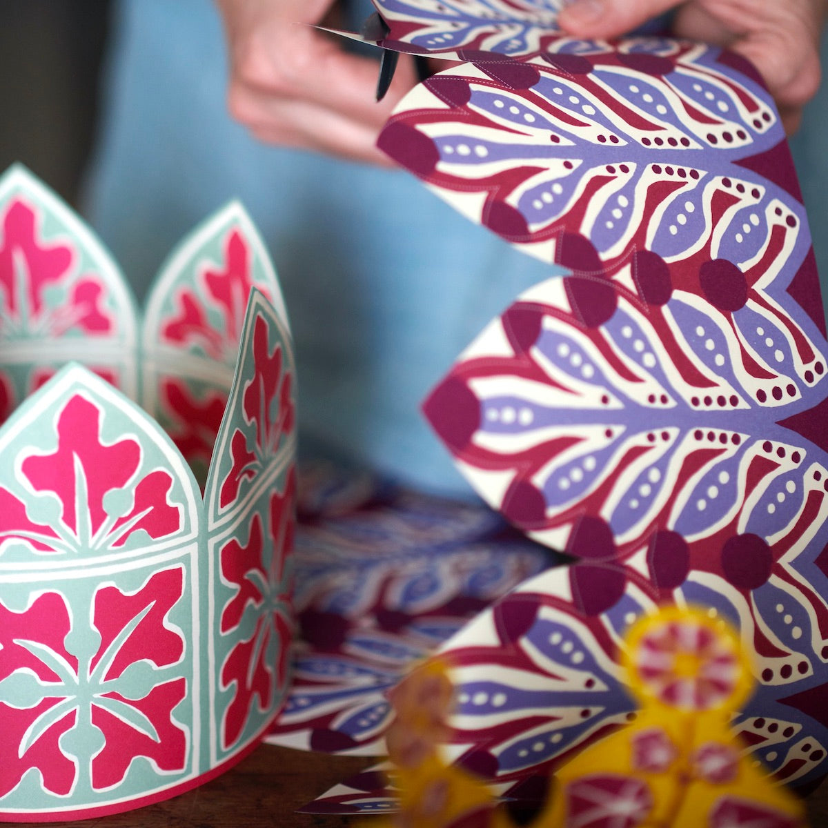 Colorful paper crafts with intricate patterns on a blurred background