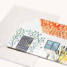 Close up shot of cottage themed greetings card on a white surface