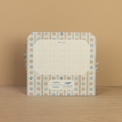 Card with floral design on a wooden surface and beige background