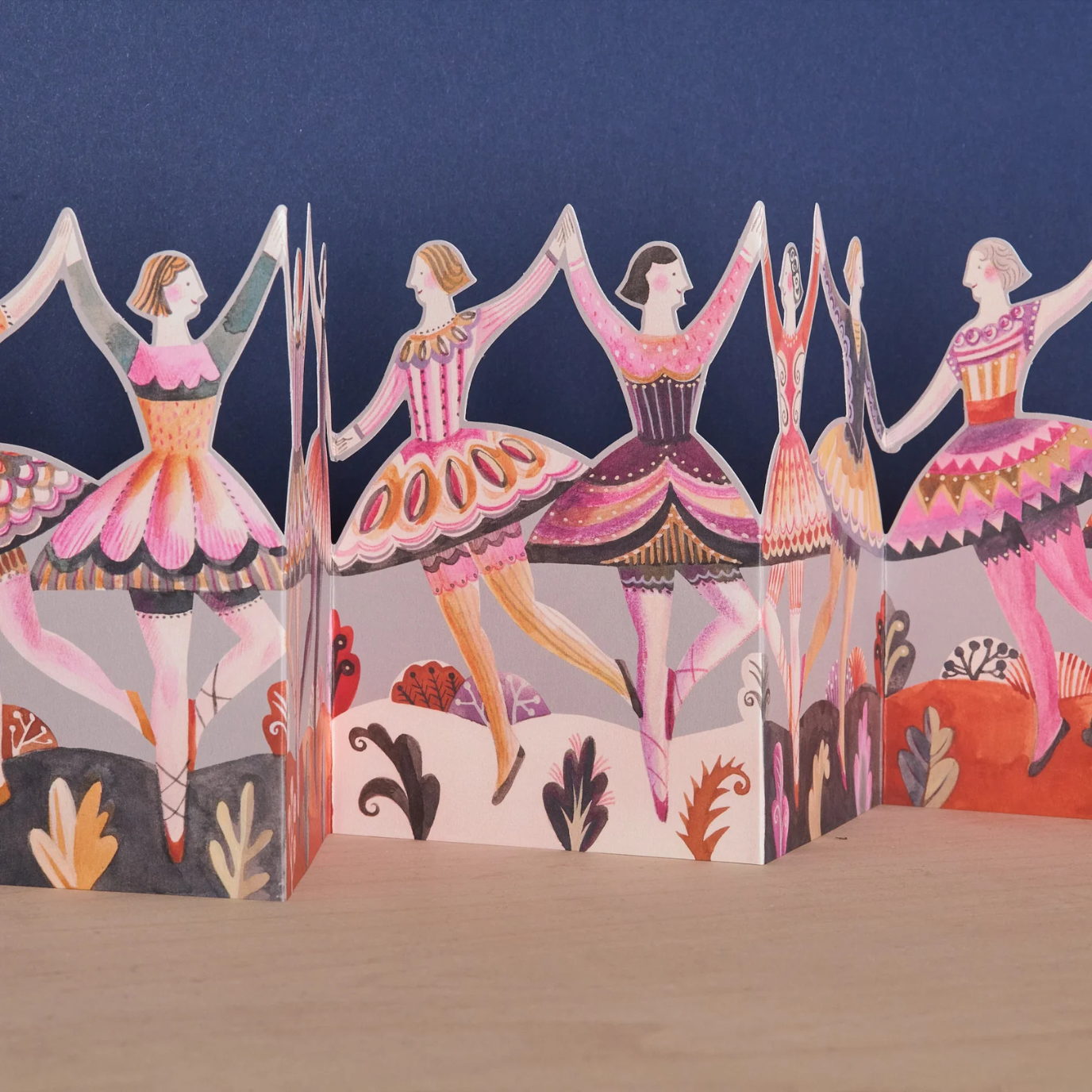 Concertina card with ballerina figures on a blue background