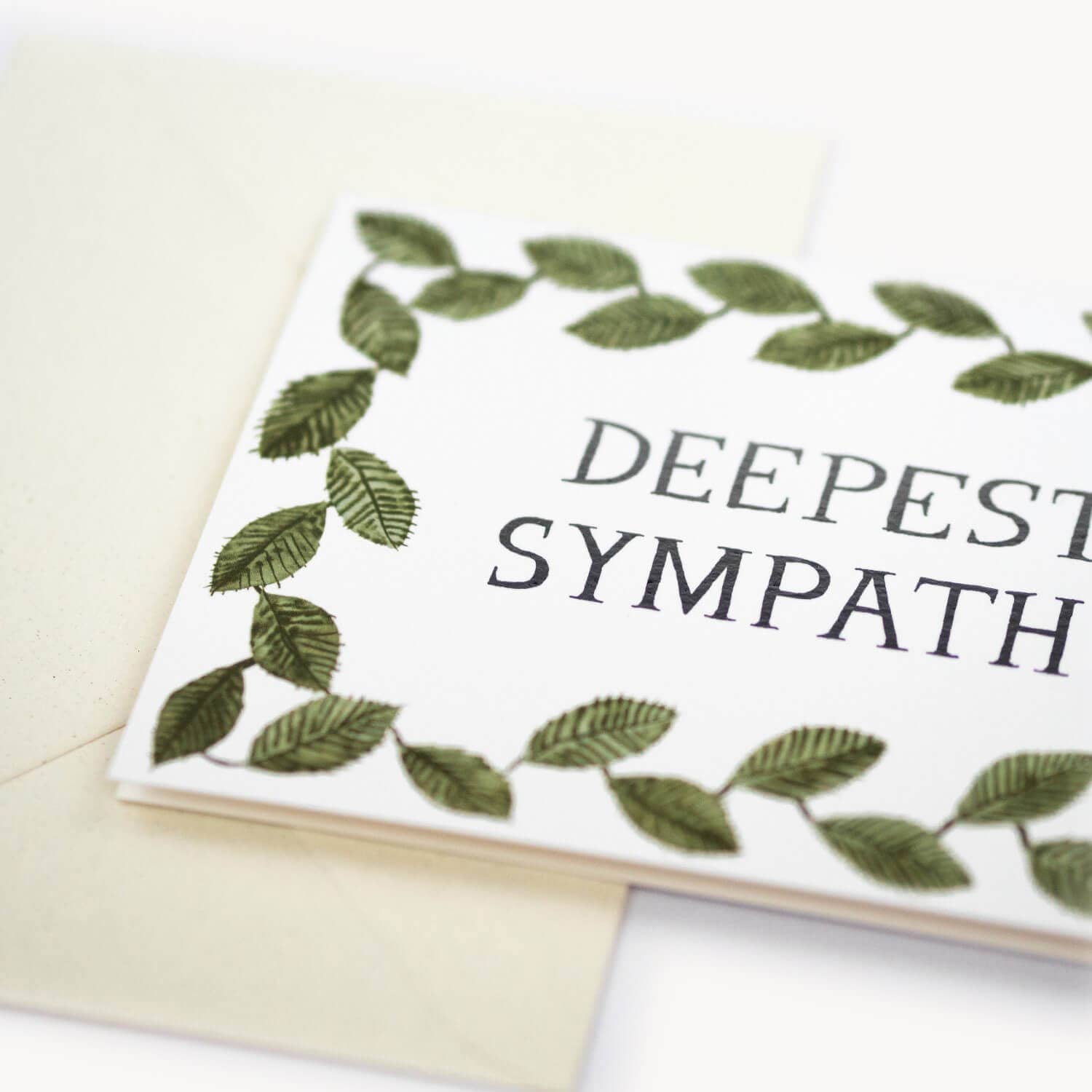 Greeting card with 'Deepest Sympathies' text and leaf design on a white background