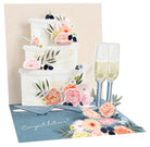 Greeting card with a floral cake and champagne glasses design on a beige background
