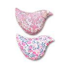 Two pink floral-patterned bird-shaped sachets on a white background
