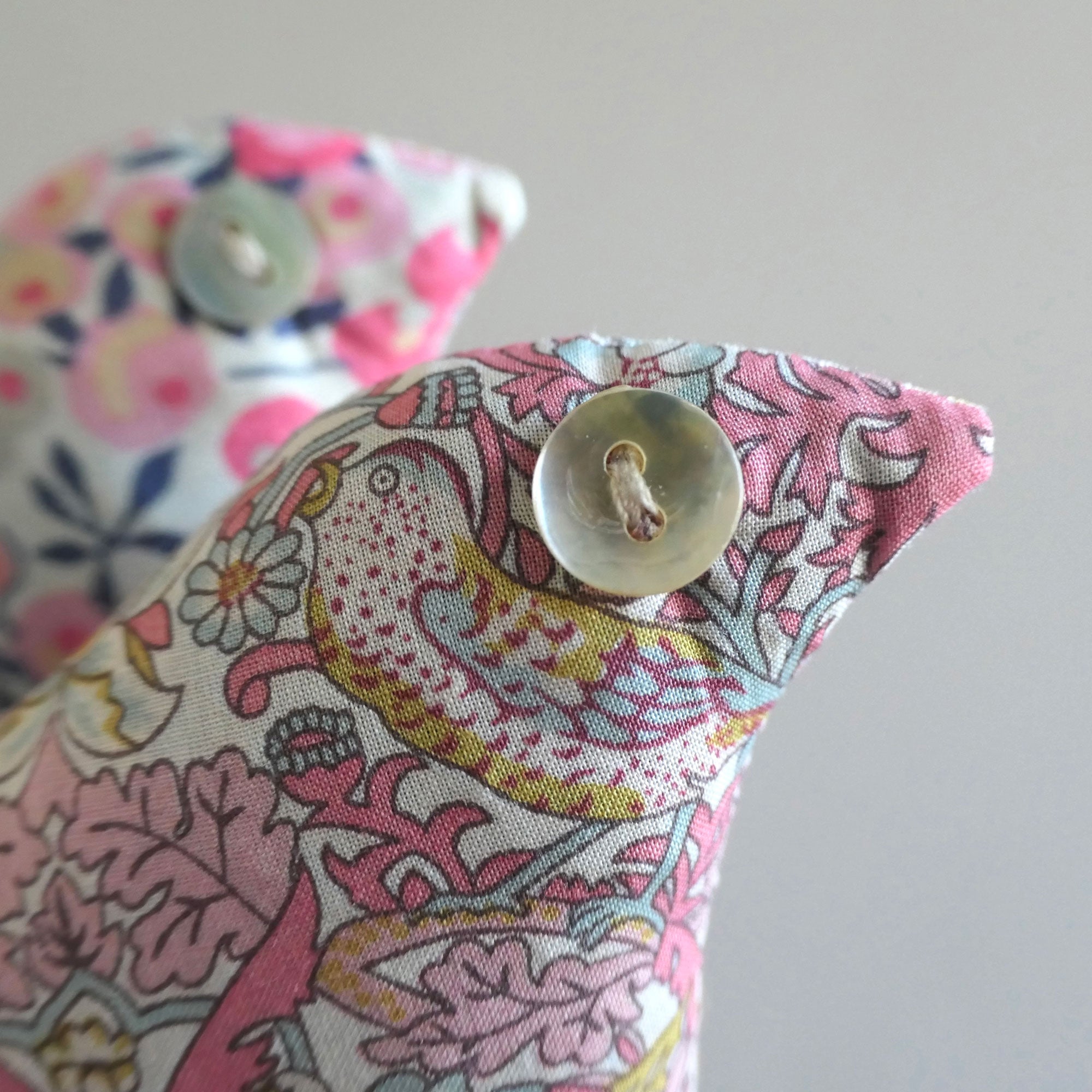Liberty Floral fabric lavender sachet with a button on a grey background