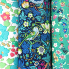 Three cotton hankies and nature-themed fabric with birds and flowers.