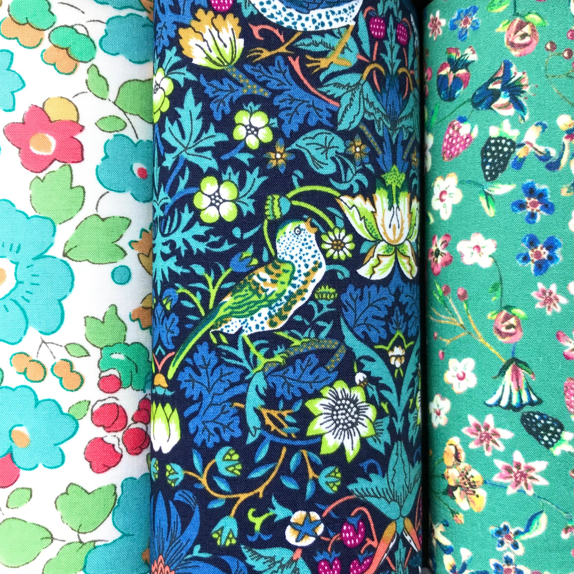 Three cotton hankies and nature-themed fabric with birds and flowers.