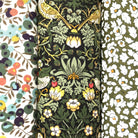 Three floral fabric patterns in green Liberty cotton side by side.