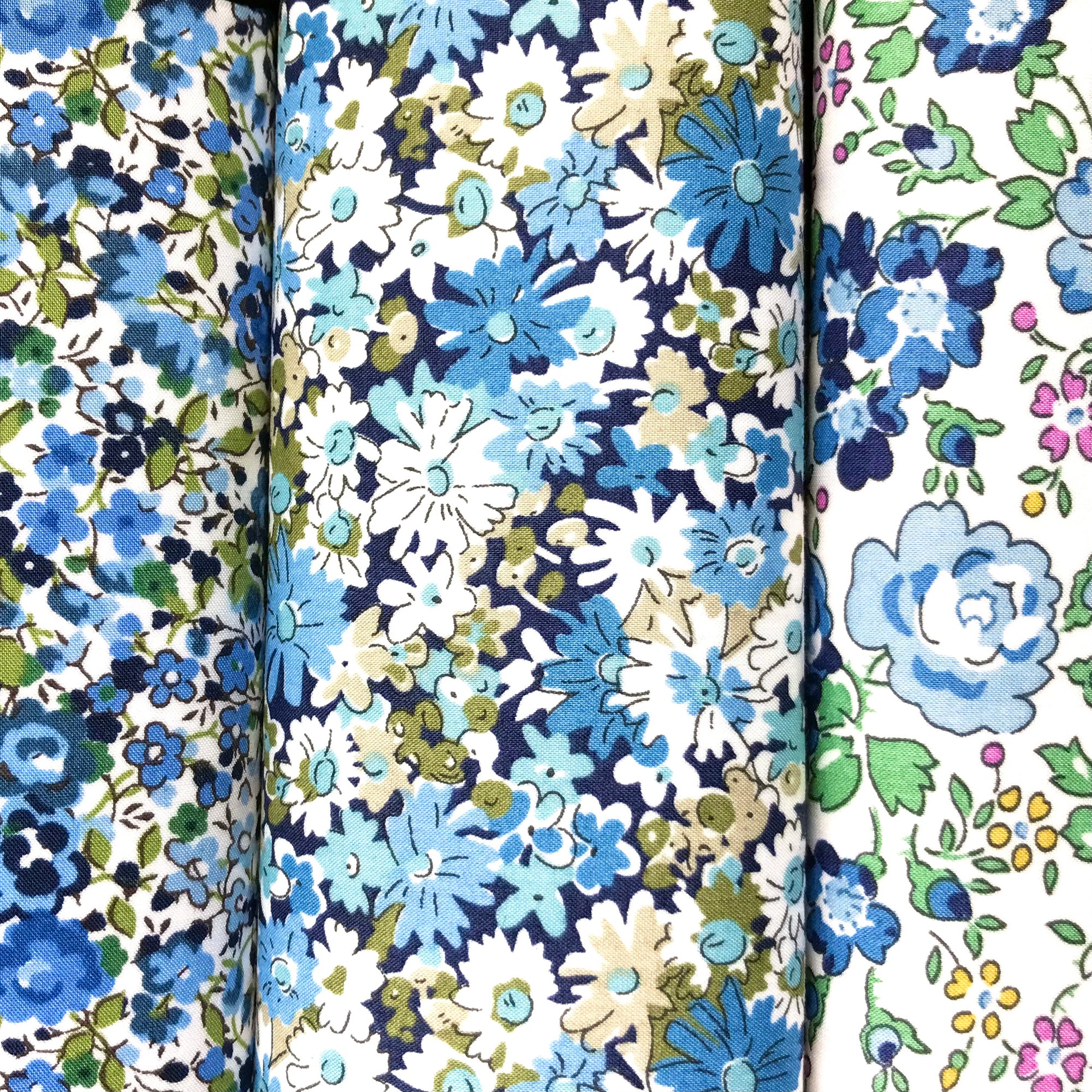 Three floral cotton hankies with blue, green and white patterns.