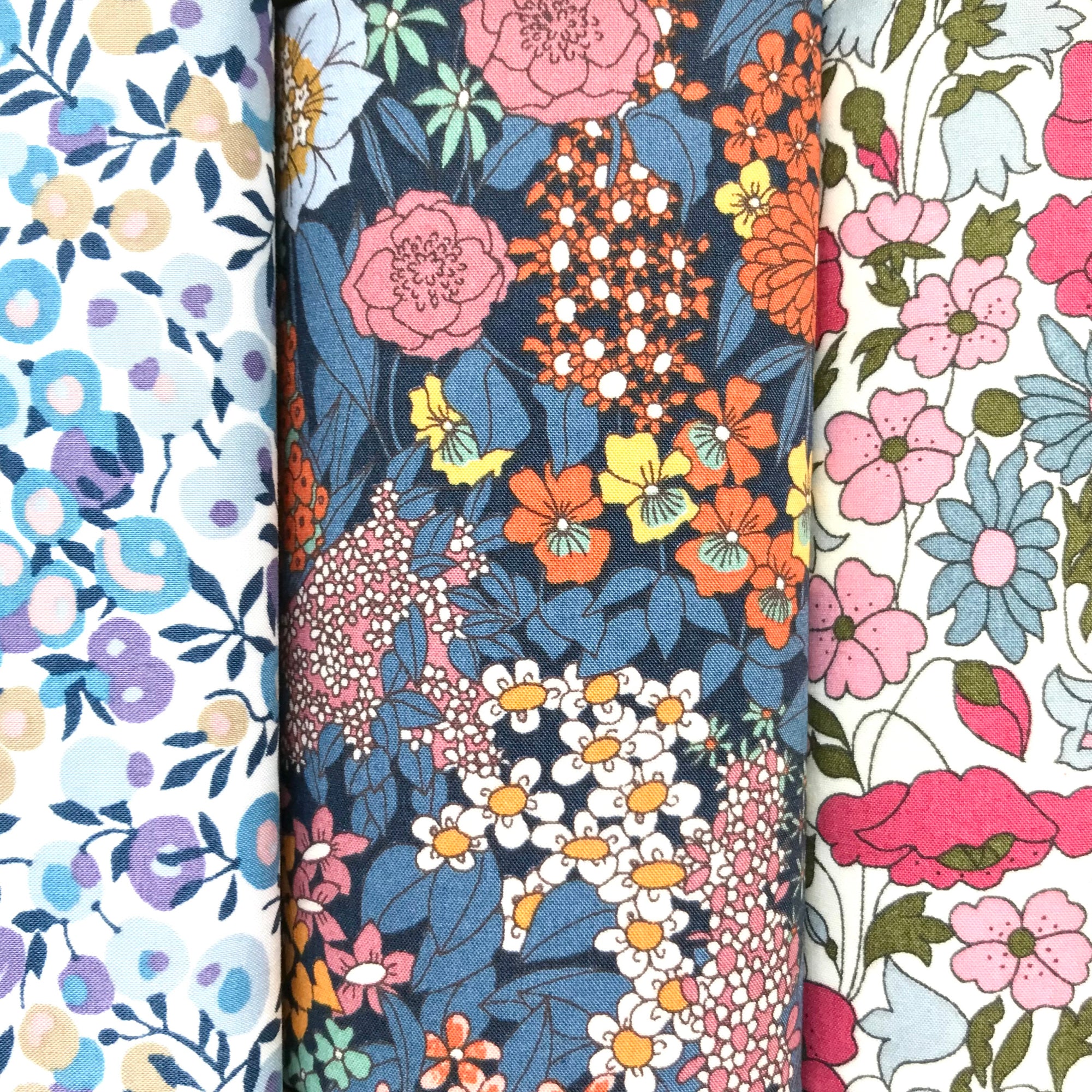 Three floral cotton hankies in purple and pink Liberty prints