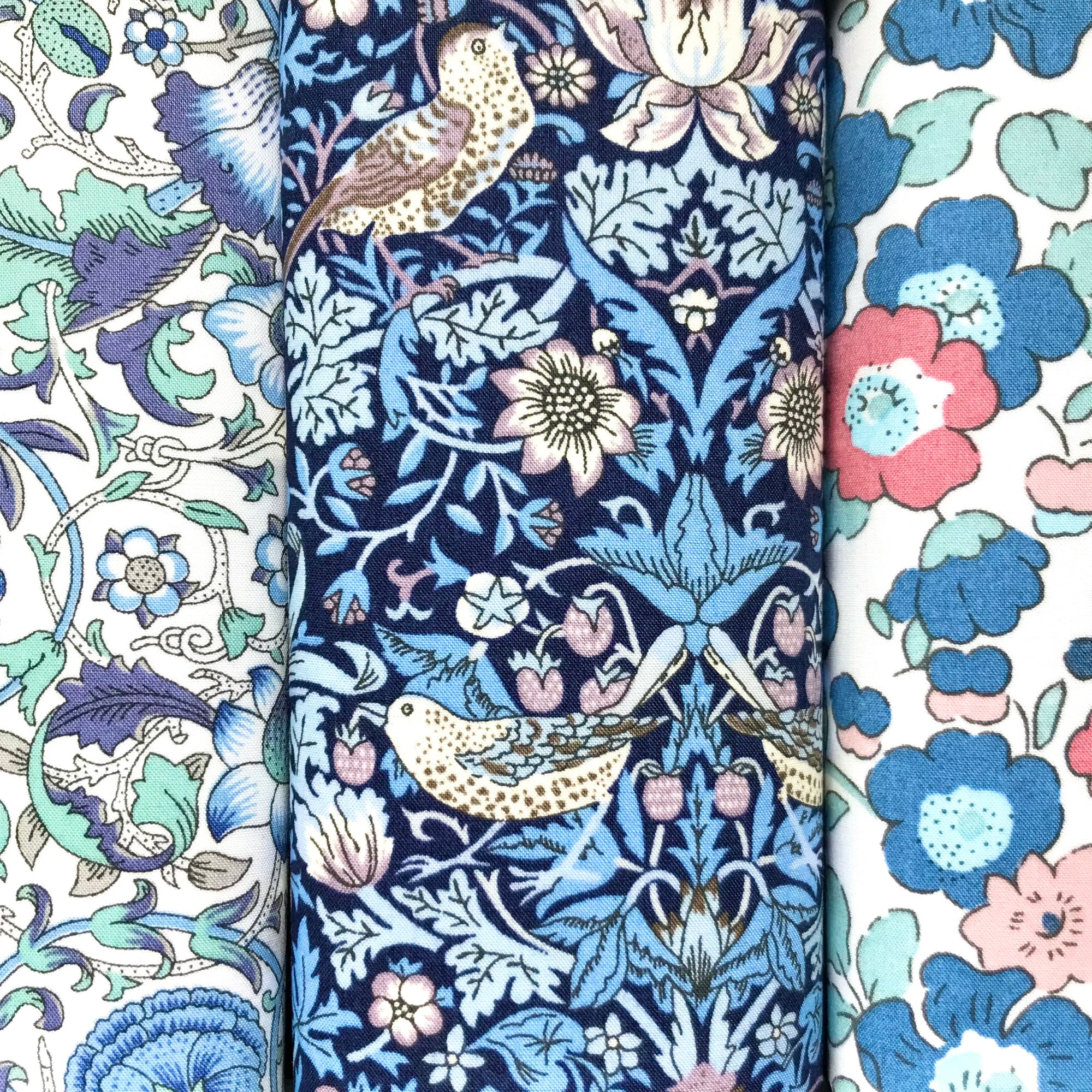 Three blue cotton hankies in floral prints