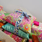 Colourful fabric flowers tied together with a decorative ribbon on a white background