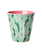 Melamine cup with peacock and floral design on a light green background