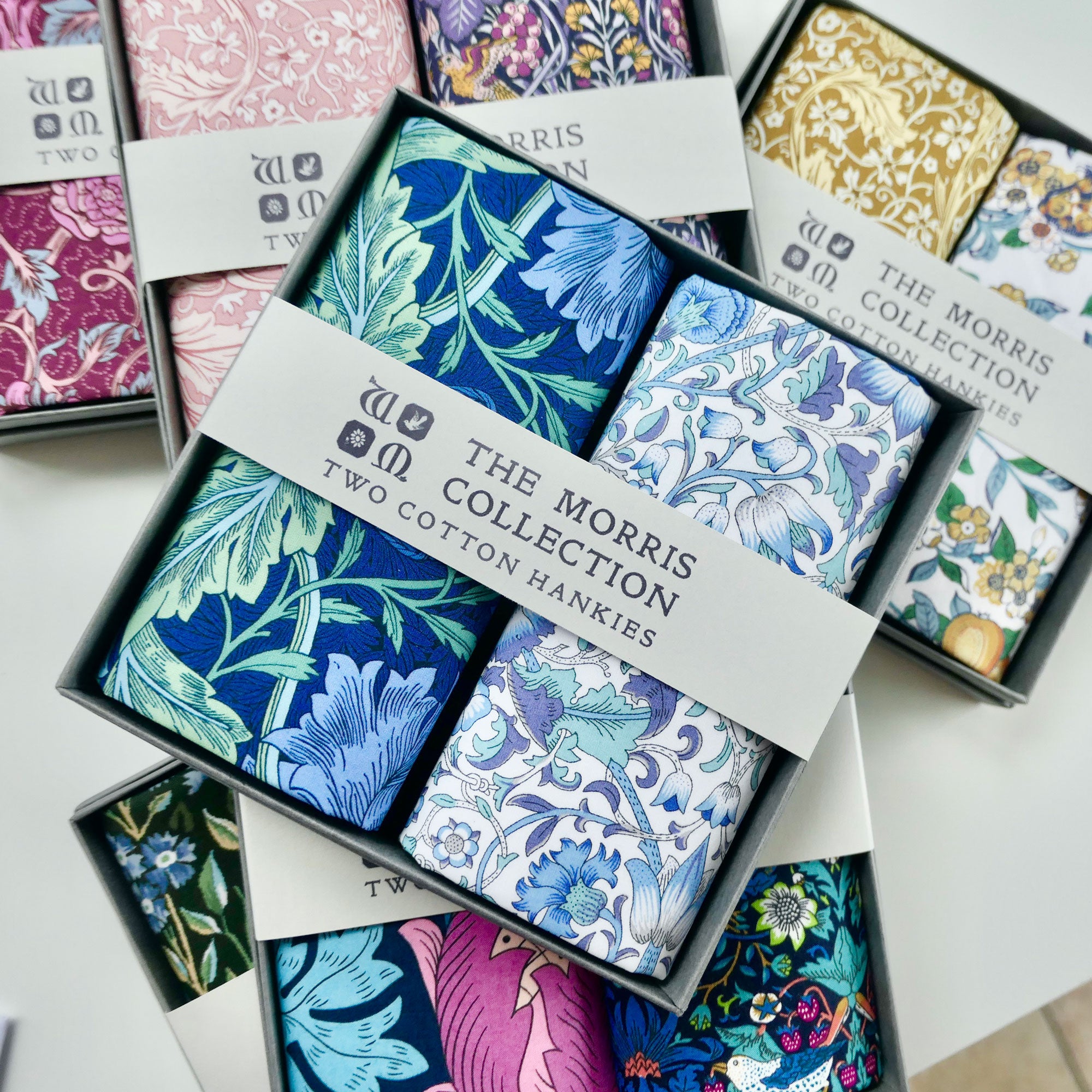 Box of The Morris Collection cotton hankies with floral patterns.