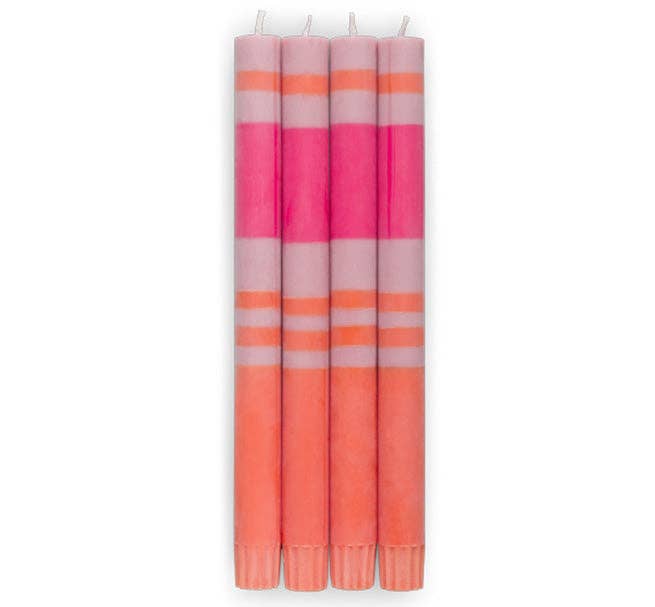 Set of four striped candles in pink and orange on a white background