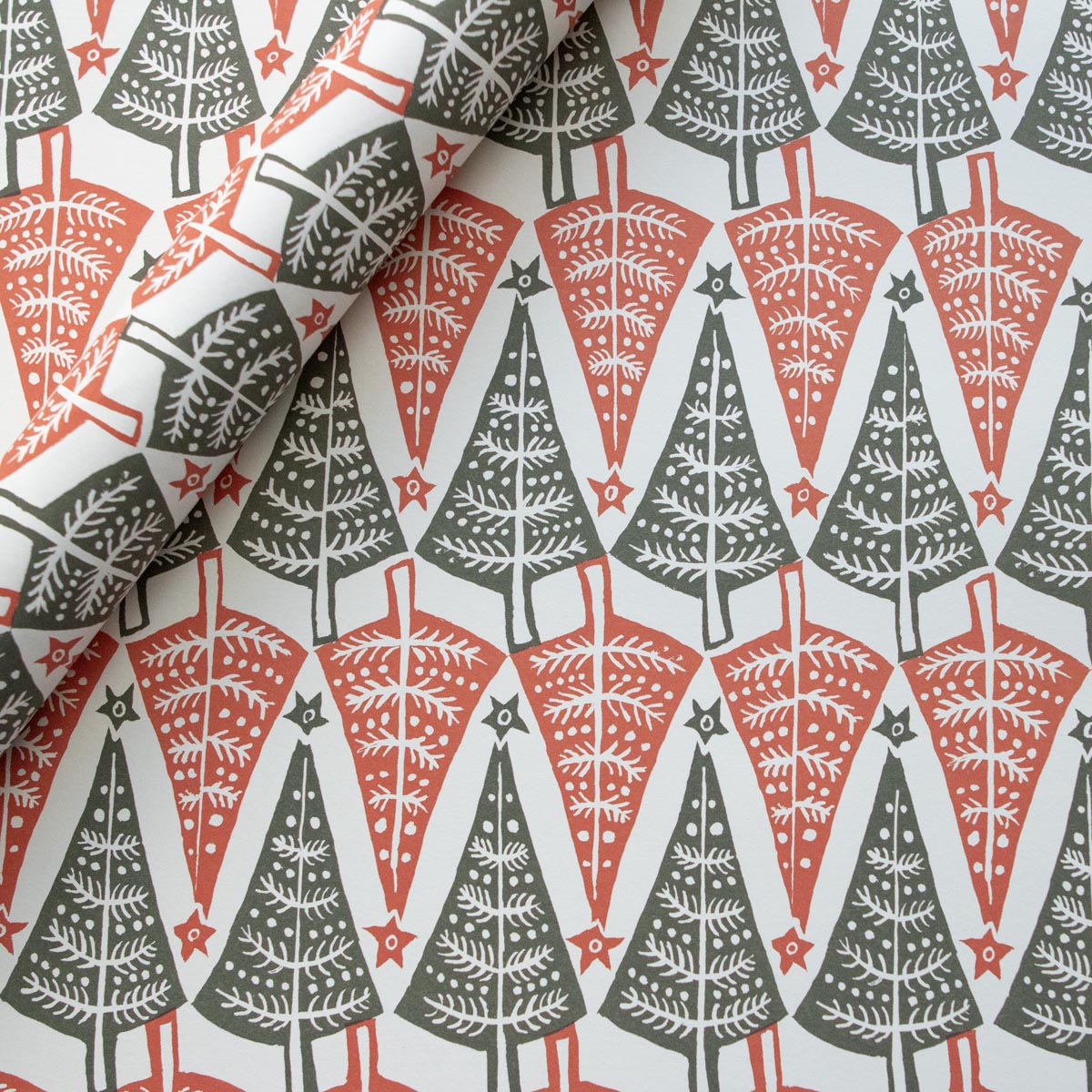 Patterned fabric with Christmas tree design in red, gray, and white.