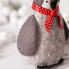 Stuffed animal with a red polka dot bow on a blurred background
