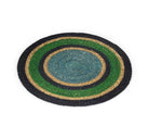 A round braided mat with concentric rings of black, green, natural tan, and a blue-grey centre, shown on a plain white background.