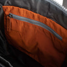 Close-up of a zipper on an orange and black fabric surface