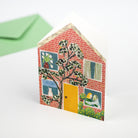 Card with a house design featuring windows and a door, with a green envelope on a white background.