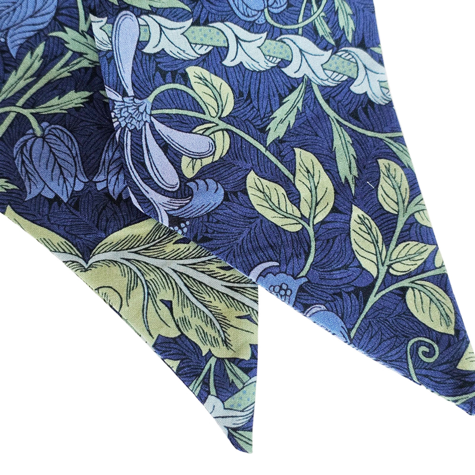 Blue fabric with green leaf pattern on a white background