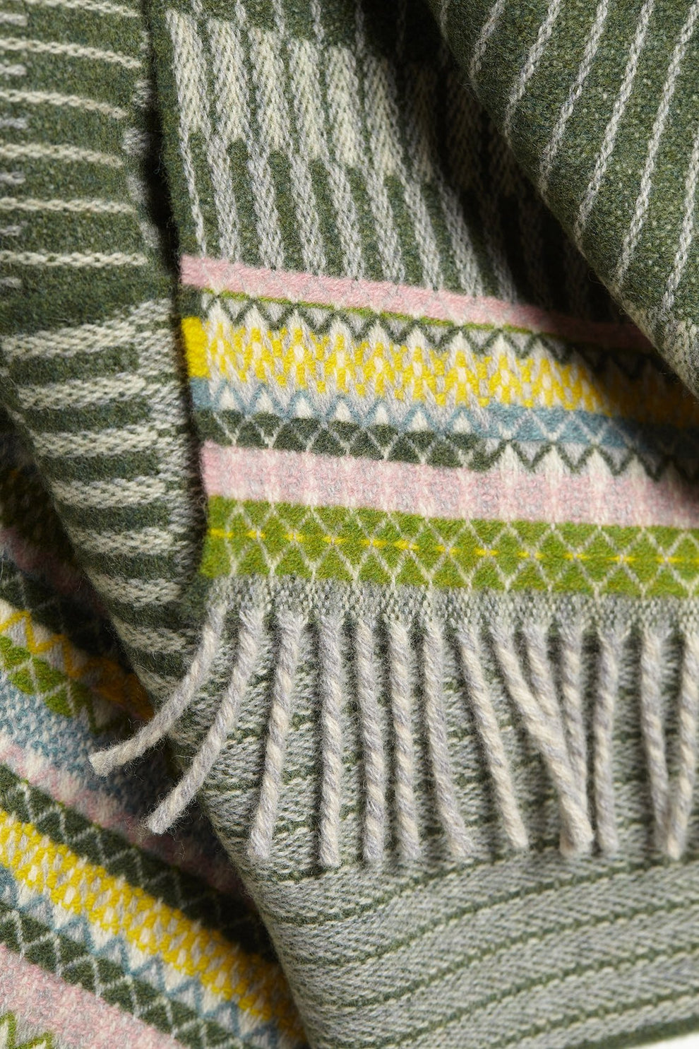 Close-up of a patterned fabric with green, pink, and yellow colors.