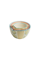 Set of four colorful ceramic jugs stacked on a white background